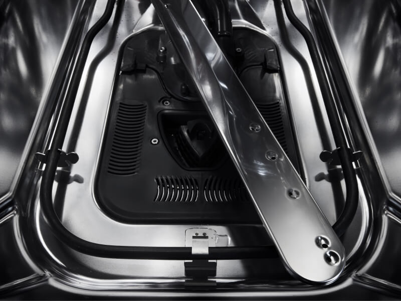 Close-up of a spray arm inside a dishwasher