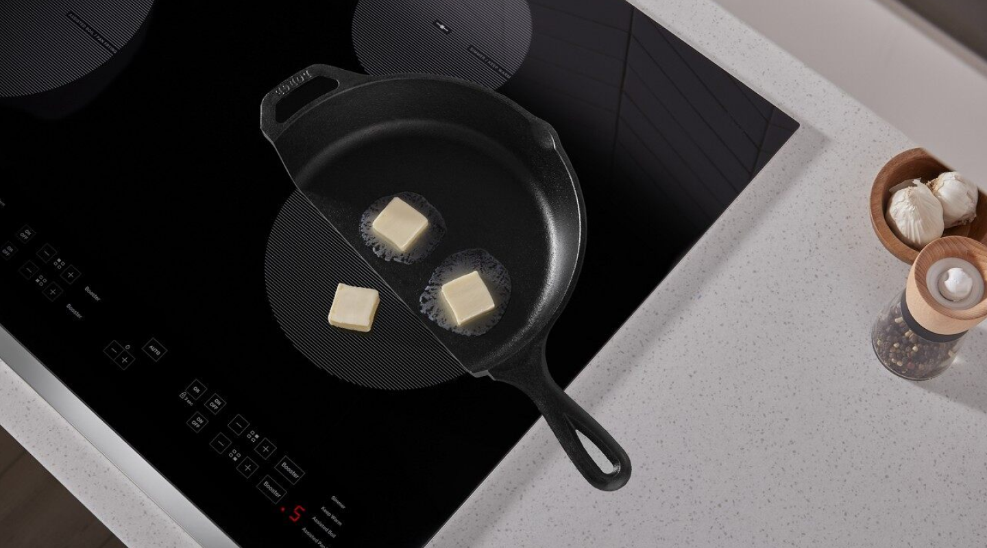 Butter in a cast iron pan melting on a Whirlpool® induction cooktop Butter in a cast iron pan melting on a Whirlpool® induction cooktop