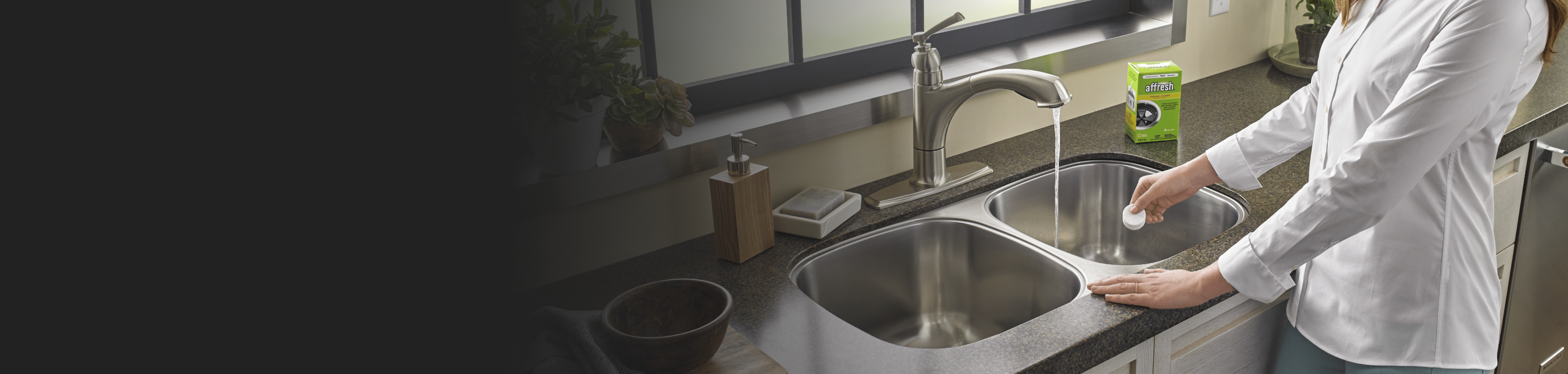 Person adding affresh® to a kitchen sink drain