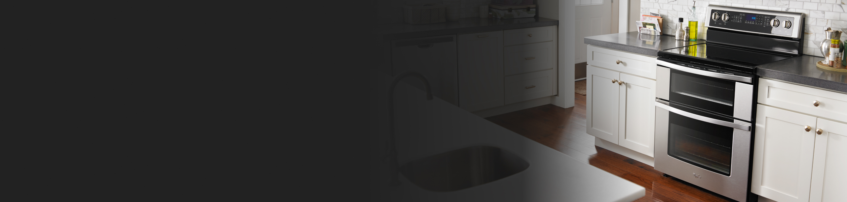 Kitchen with white cabinets and dark countertops