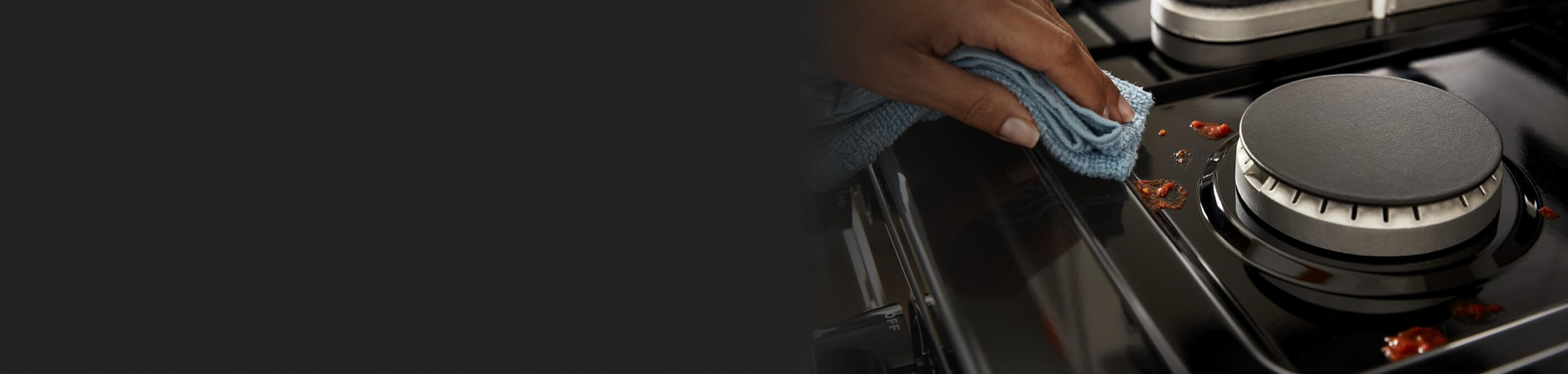 Person wiping a stovetop