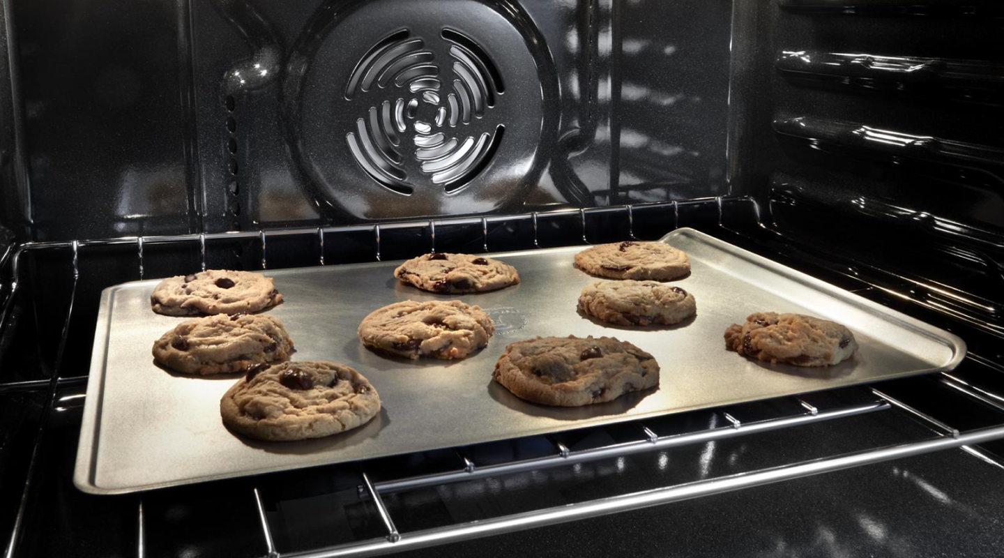 Chocolate chip cookies baking in an oven Chocolate chip cookies baking in an oven