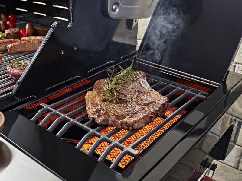 Steak with herbs on a grill Steak with herbs on a grill