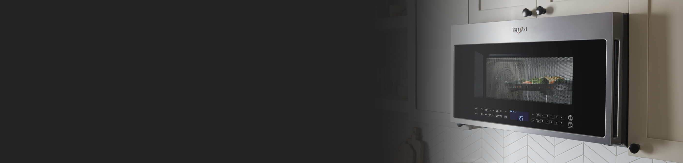 Over-the-range, Whirlpool® stainless steel microwave with chicken and vegetables inside