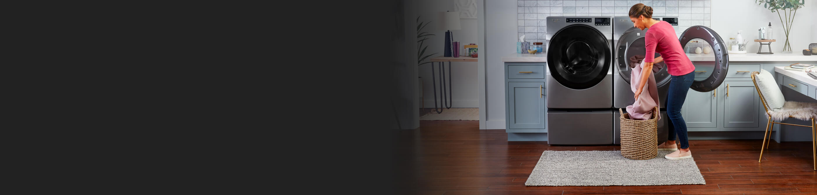 A woman preparing to dry a load of laundry using a Whirlpool® washer and dryer pair