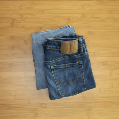 Two pairs of completely folded pants stacked on a table