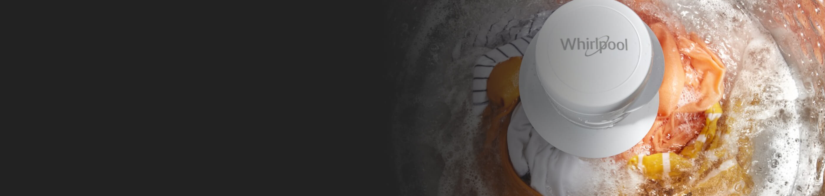 Clothing in a top load washing machine with an agitator going through an active wash cycle