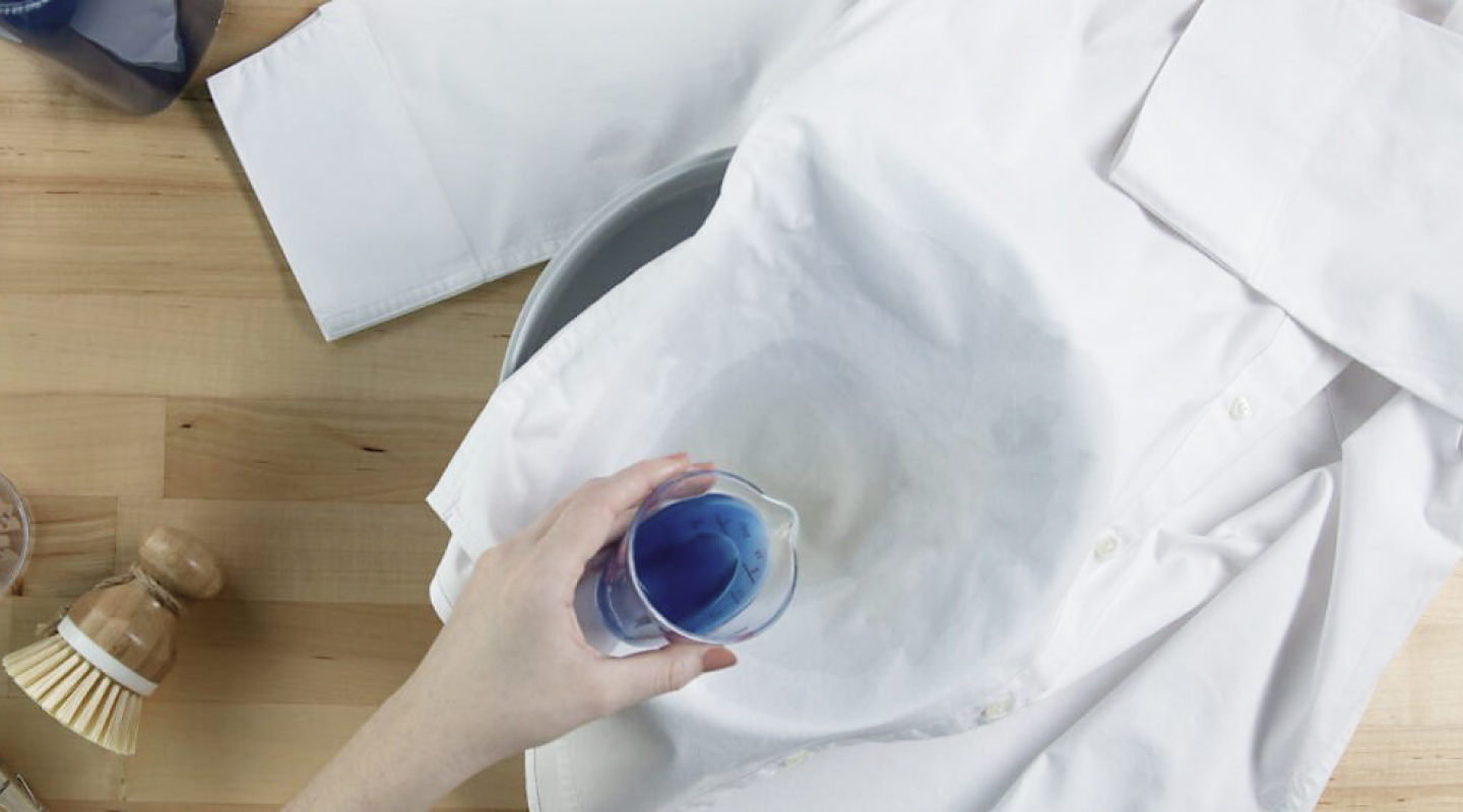 Person pretreating a stain Person pretreating a stain