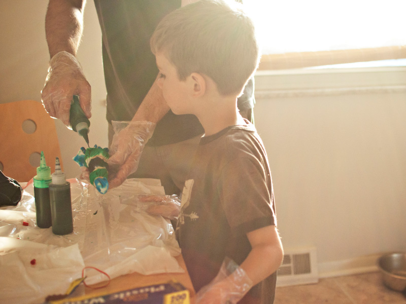 An adult and child crafting with paints An adult and child crafting with paints