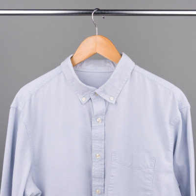 A button up shirt drying on a hanger