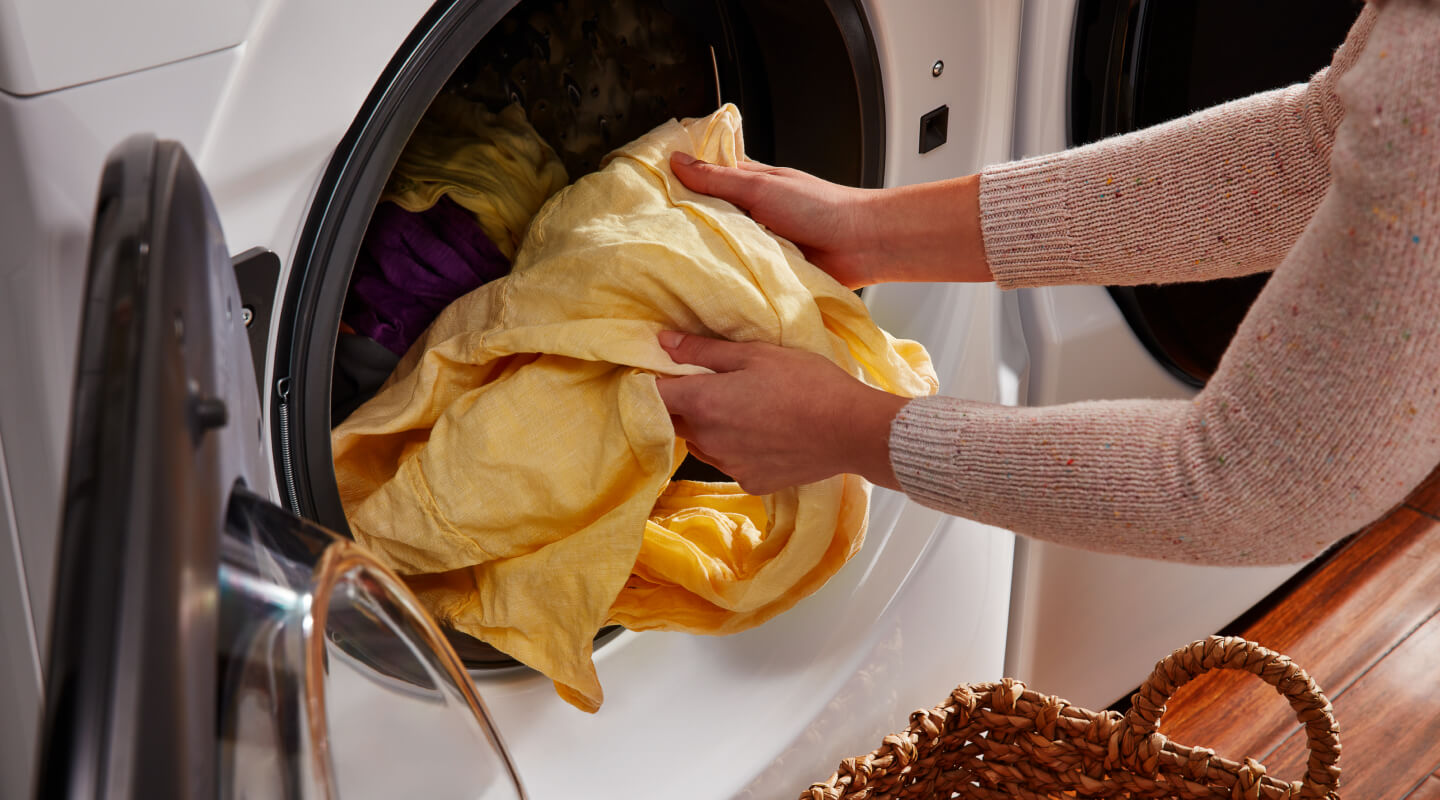 Person unloading front load washing machine