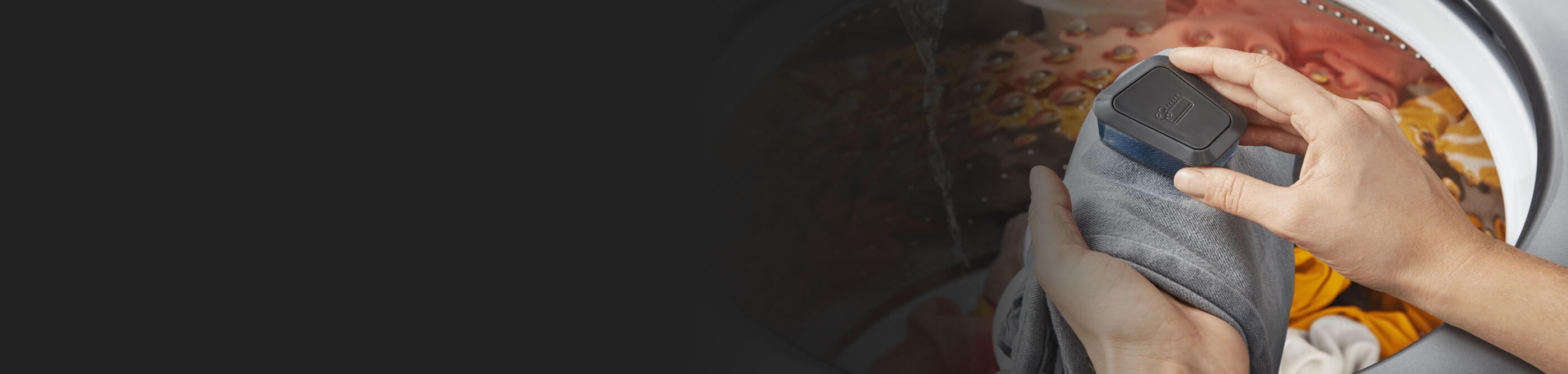 Hand scrubbing stains out of clothes at a washing machine pretreat station