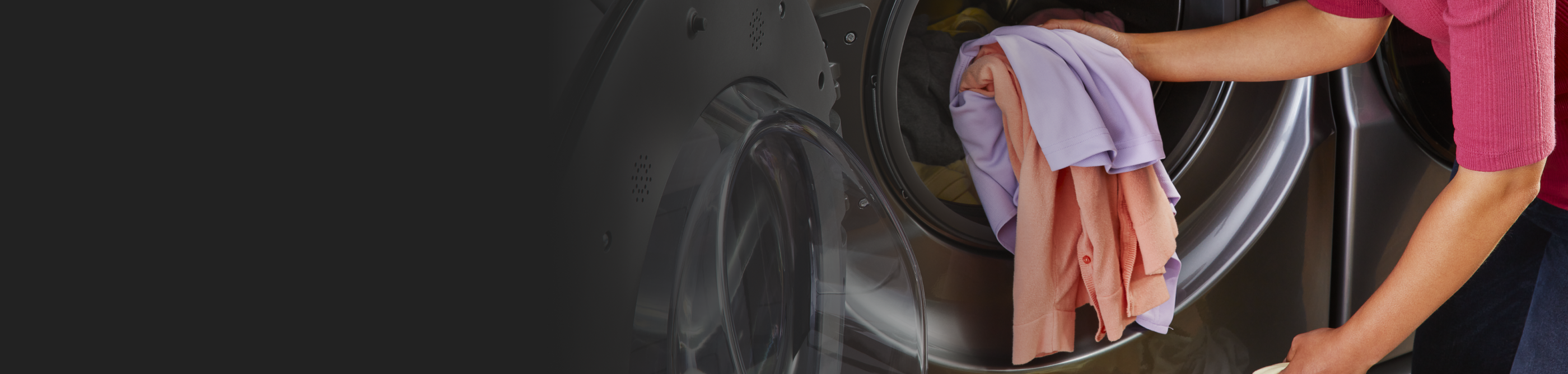 A person putting clothes into a Whirlpool® dryer