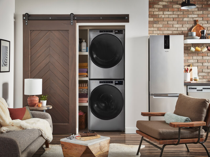 A stacked Whirlpool® Washer and Dryer in a laundry closet