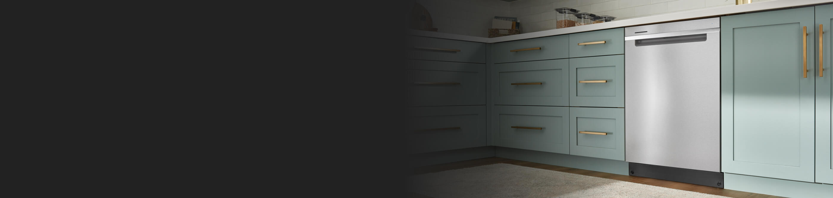 A Whirlpool® Dishwasher surrounded by teal cabinetry