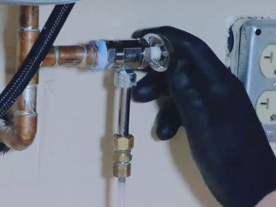 A person turning off a water valve