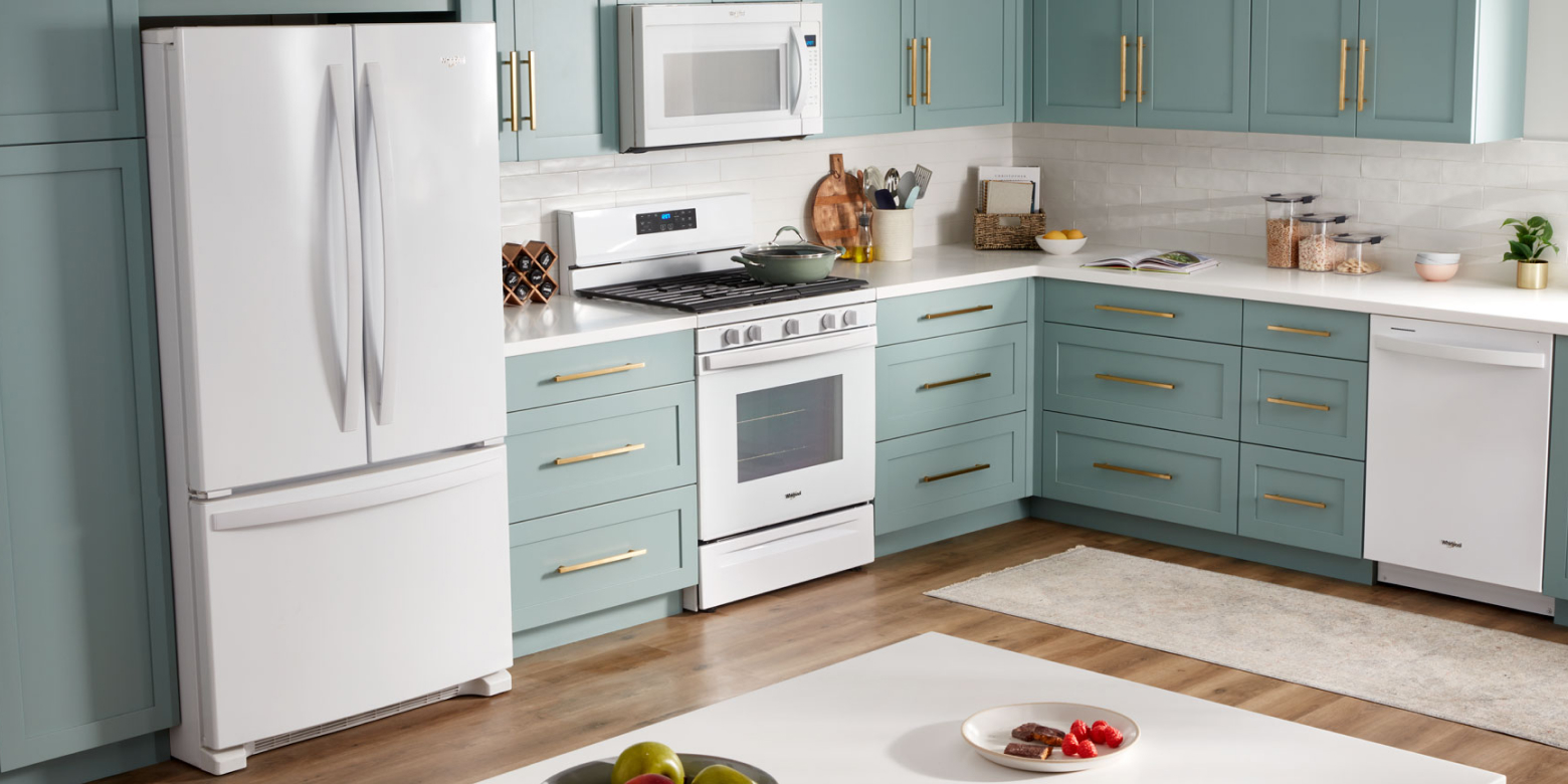 A white refrigerator, microwave, oven and dishwasher in a kitchen with teal cabinets A white refrigerator, microwave, oven and dishwasher in a kitchen with teal cabinets