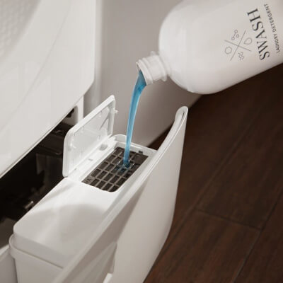 Swash® Laundry Detergent being added to washer