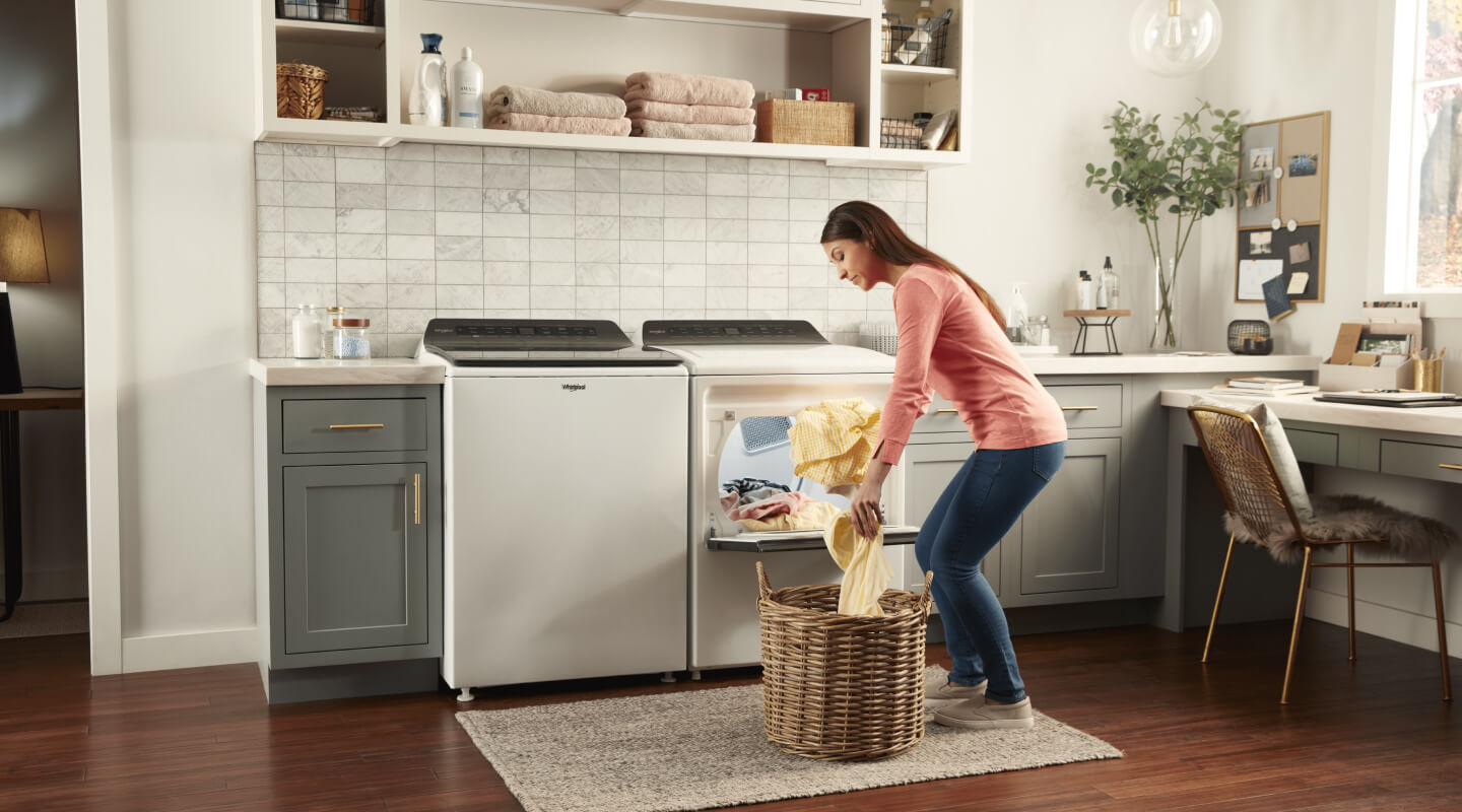 Woman loading clothes into a front load washer