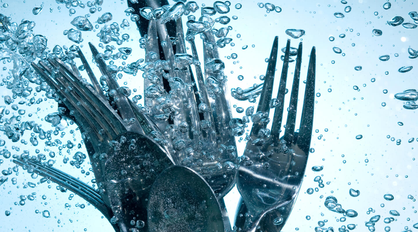 An image of silverware surrounded by water