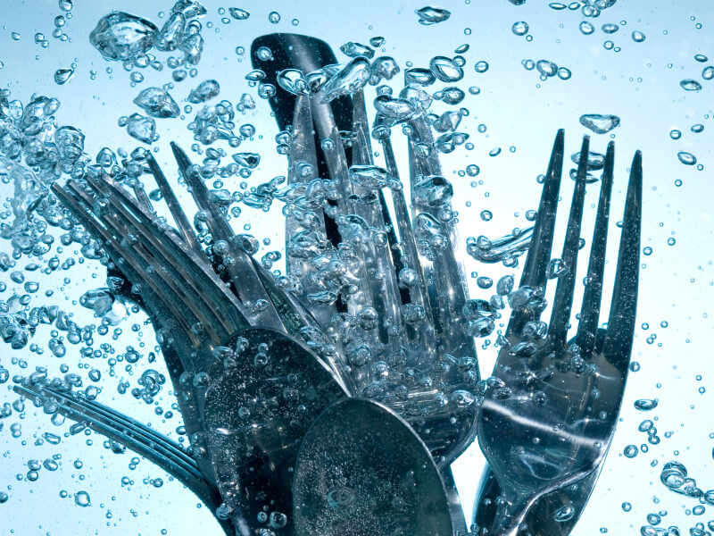 An image of silverware surrounded by water