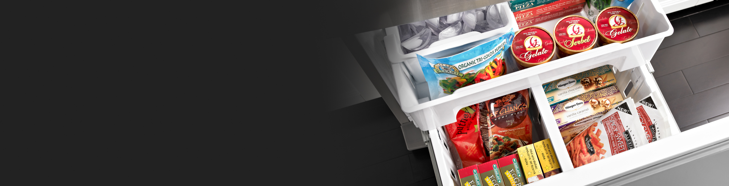 White freezer drawers opened showing a variety of frozen foods