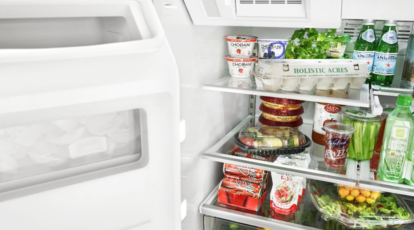 Open Whirlpool® Refrigerator filled with food Open Whirlpool® Refrigerator filled with food