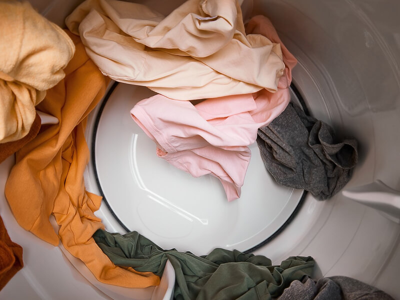 Clothes moving through a dryer