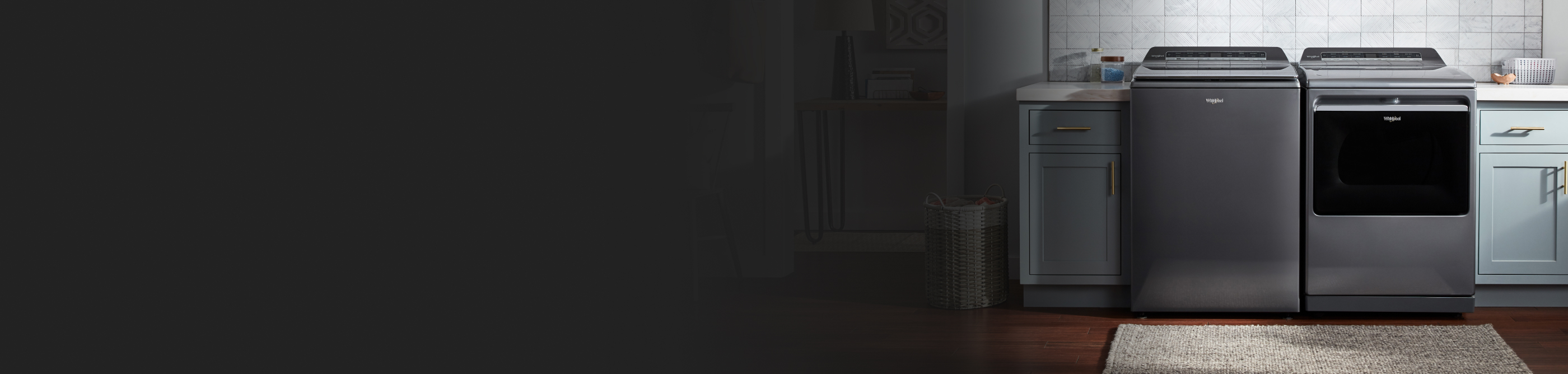 Whirlpool® front-load washer and dryer in laundry room with blue cabinetry