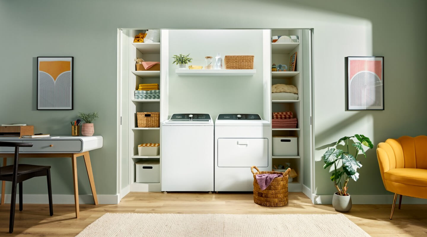 Laundry room with a white Whirlpool® Top Load Laundry Set