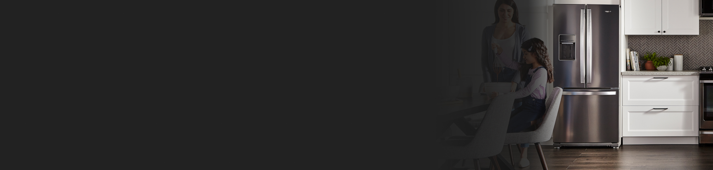 People in a kitchen with stainless steel appliances