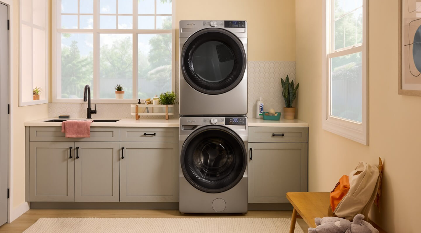 A laundry area with a stackable smart front load washer and dryer by Whirlpool brand