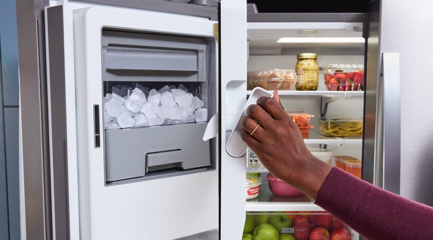 A Whirlpool® French Door Refrigerator with the freezer door open, showing an ice maker