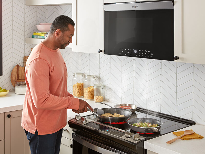 Person cooking on an electric range Person cooking on an electric range