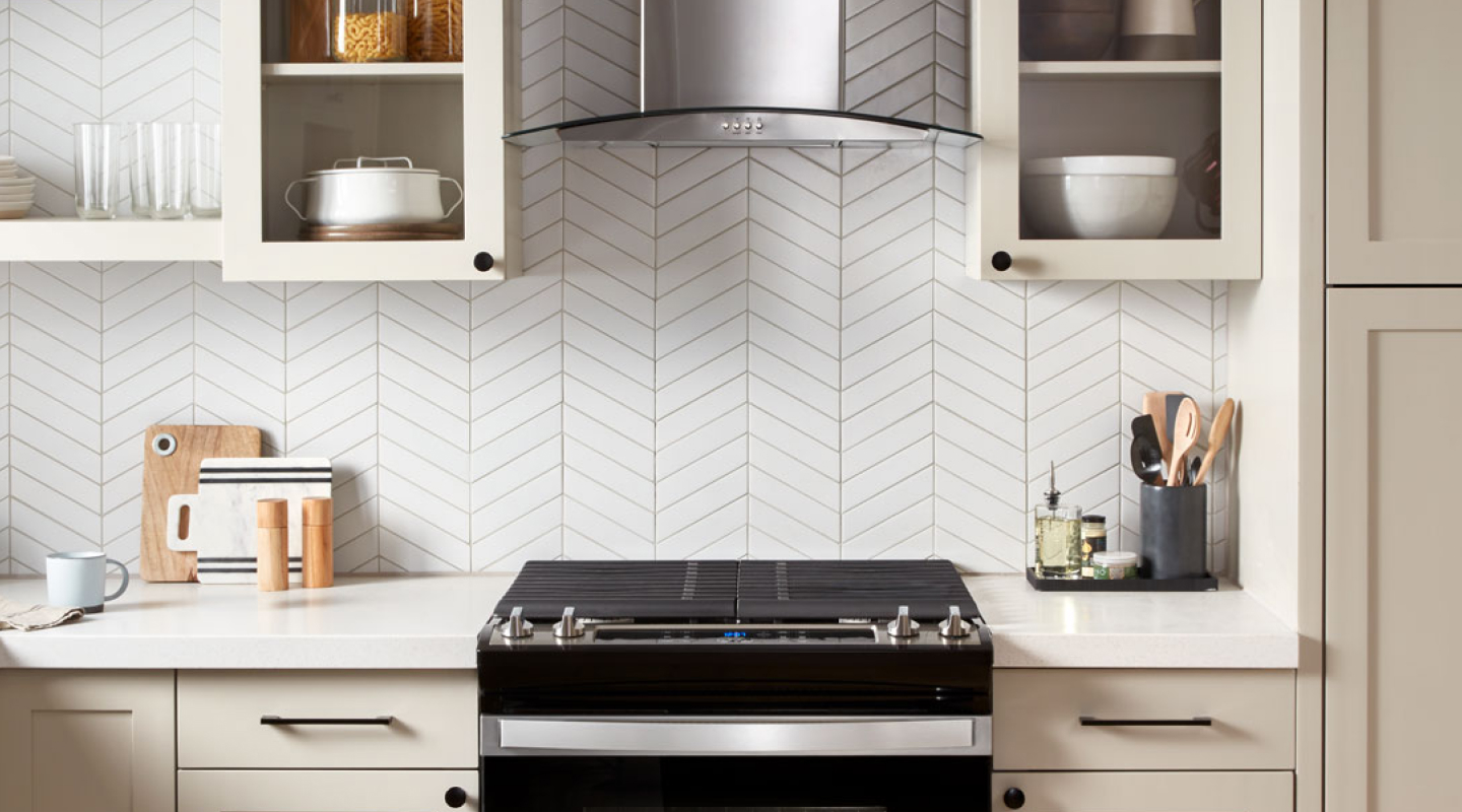 A black range and range hood in a modern kitchen A black range and range hood in a modern kitchen