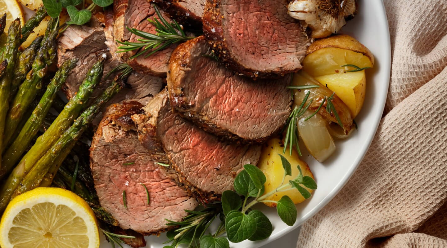 Sliced meat and potatoes on a plate