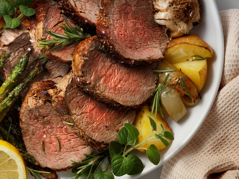 Sliced meat and potatoes on a plate