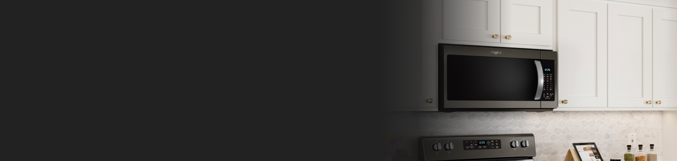 Whirlpool over-the-range microwave and oven set in a kitchen with neutral backsplash.