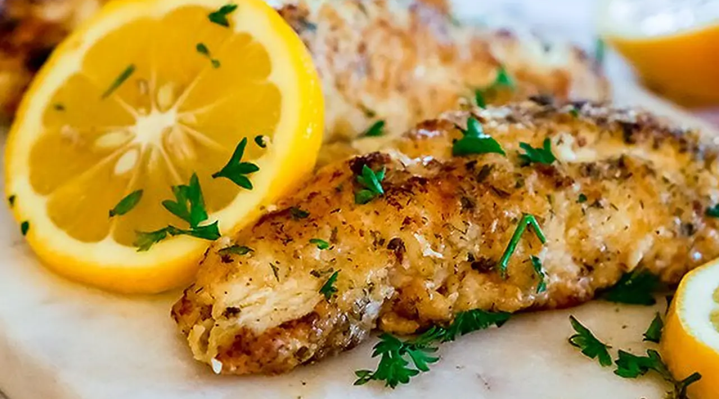 Seasoned fish with lemon slices Seasoned fish with lemon slices