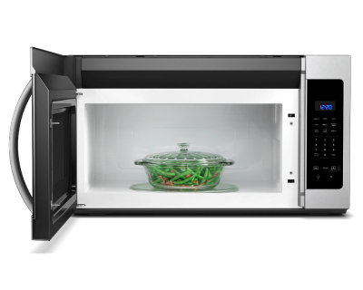 Open microwave door showing pot of green beans in a glass dish
