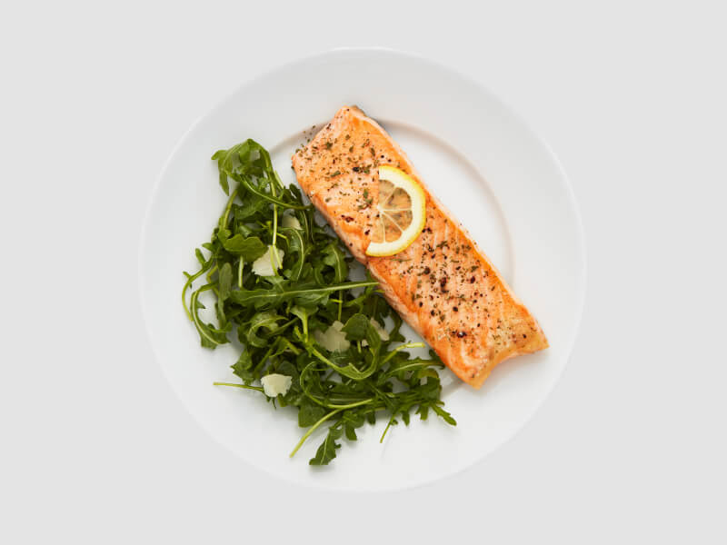 Fish and vegetables on a white plate Fish and vegetables on a white plate
