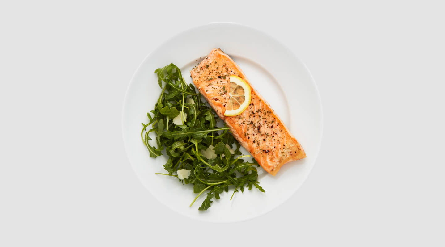 Fish and vegetables on a white plate Fish and vegetables on a white plate