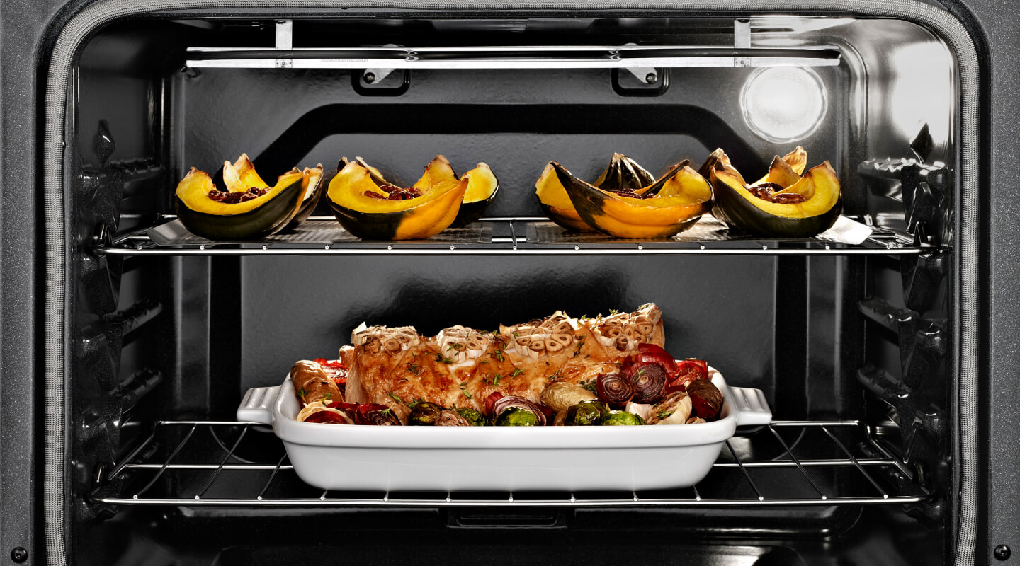 Oven open with cooked food on both racks