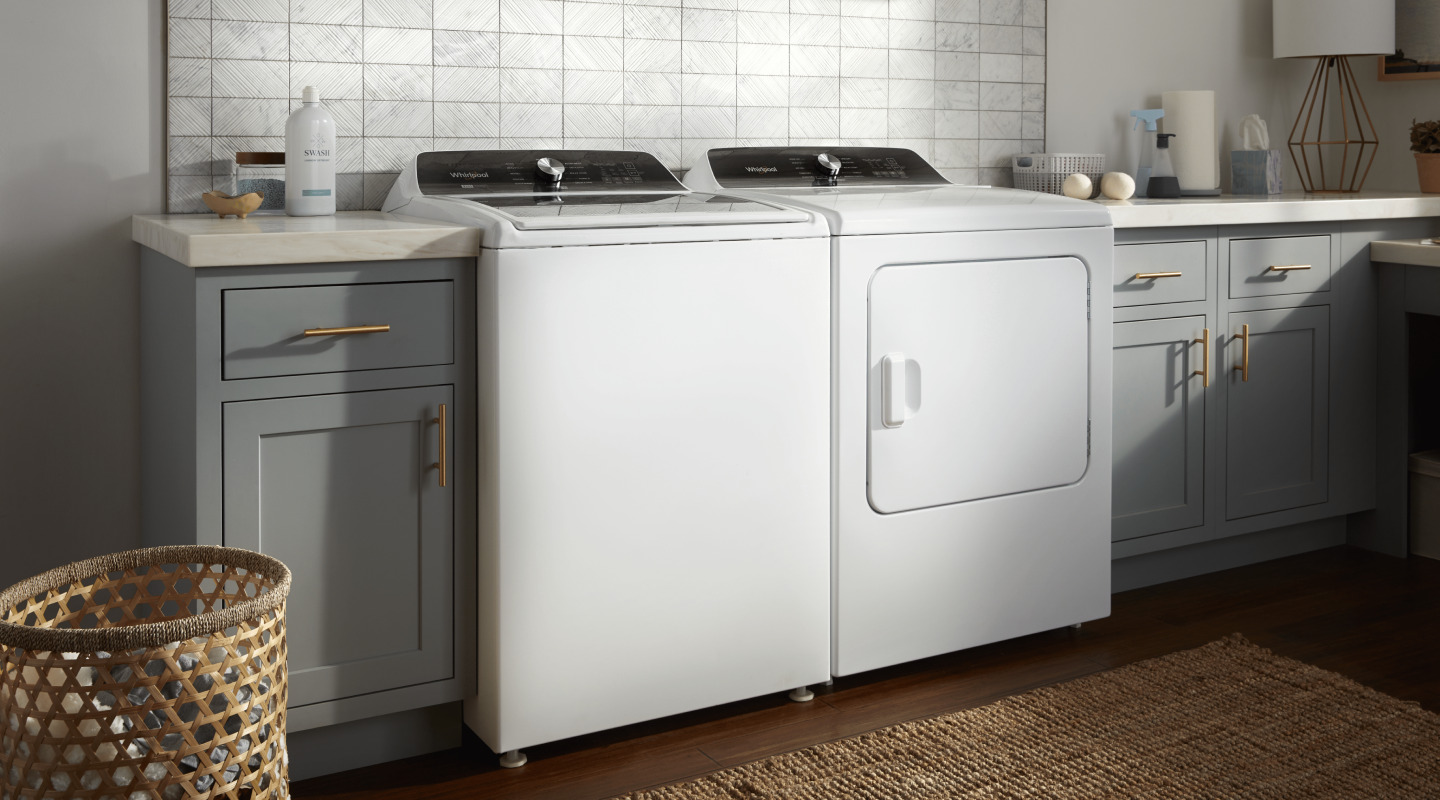 A white Whirlpool® washer and dryer pair in a modern laundry room A white Whirlpool® washer and dryer pair in a modern laundry room