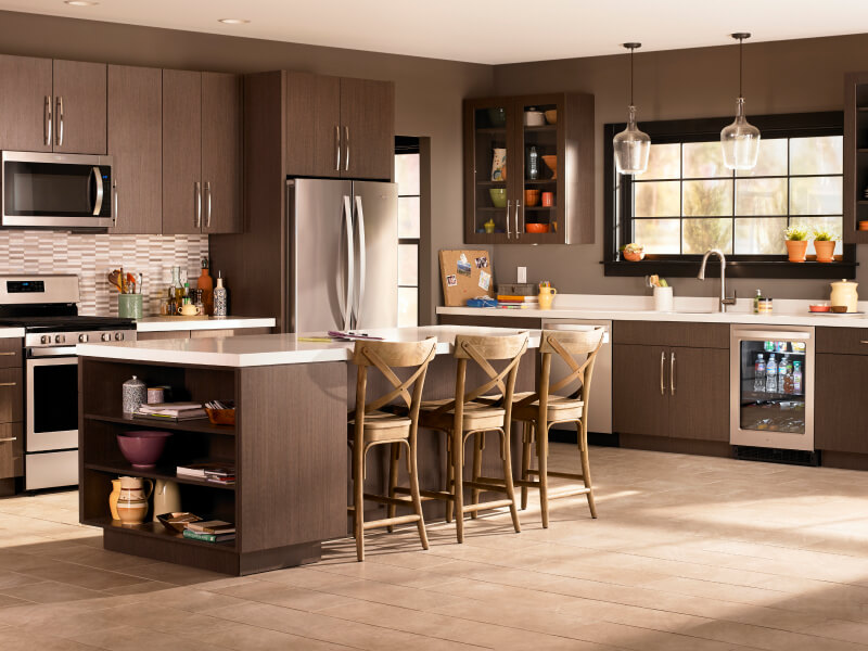 A kitchen with brown cabinets and stainless steel Whirlpool® appliances A kitchen with brown cabinets and stainless steel Whirlpool® appliances