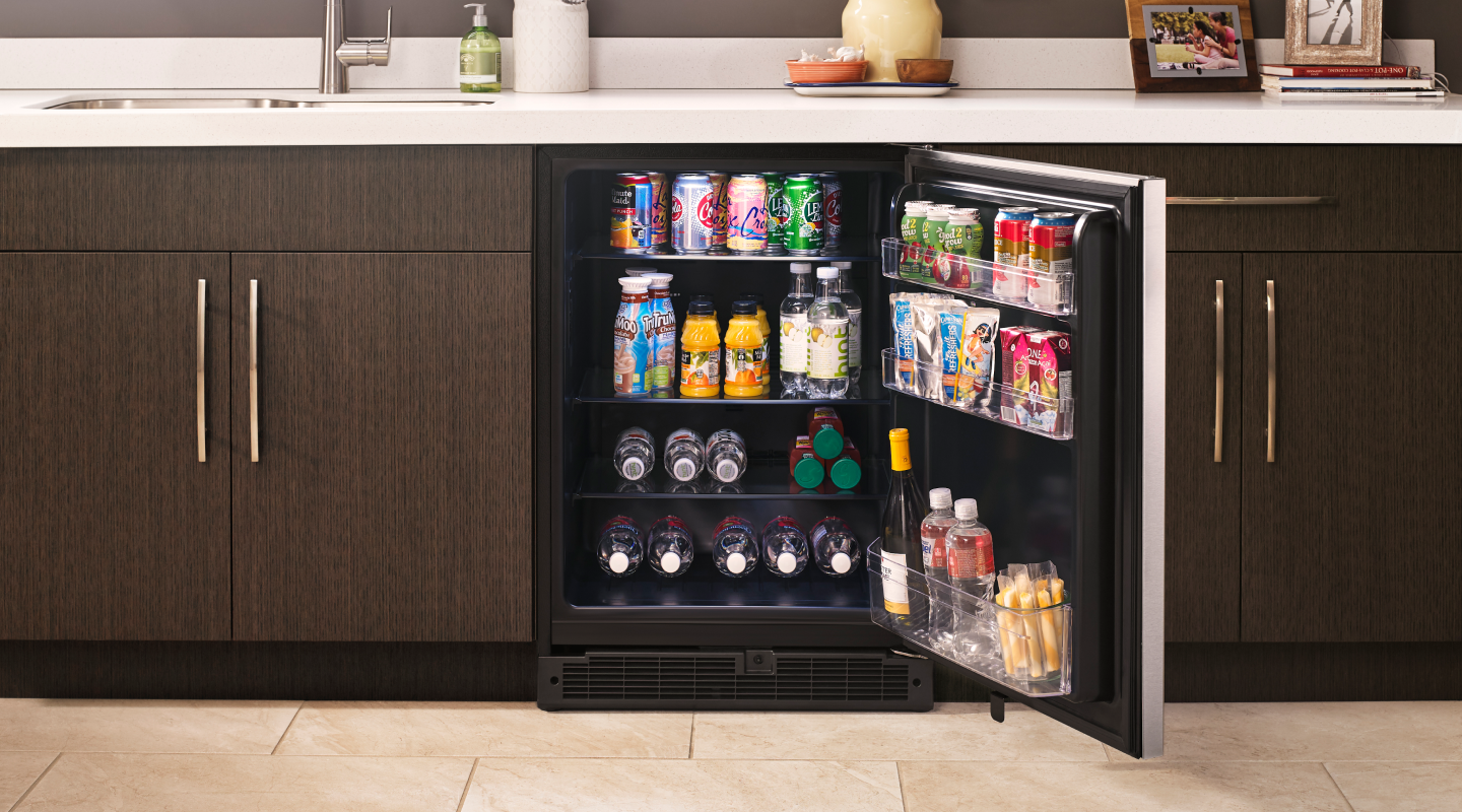 An open Whirlpool® Undercounter Refrigerator with drinks inside