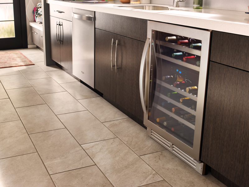 A stainless steel wine fridge in a modern kitchen with different appliances A stainless steel wine fridge in a modern kitchen with different appliances