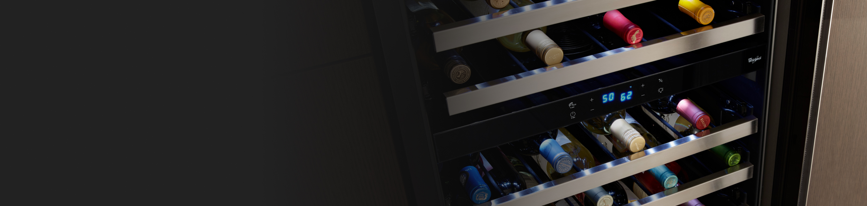 Wine bottles stored on the various levels of a wine fridge