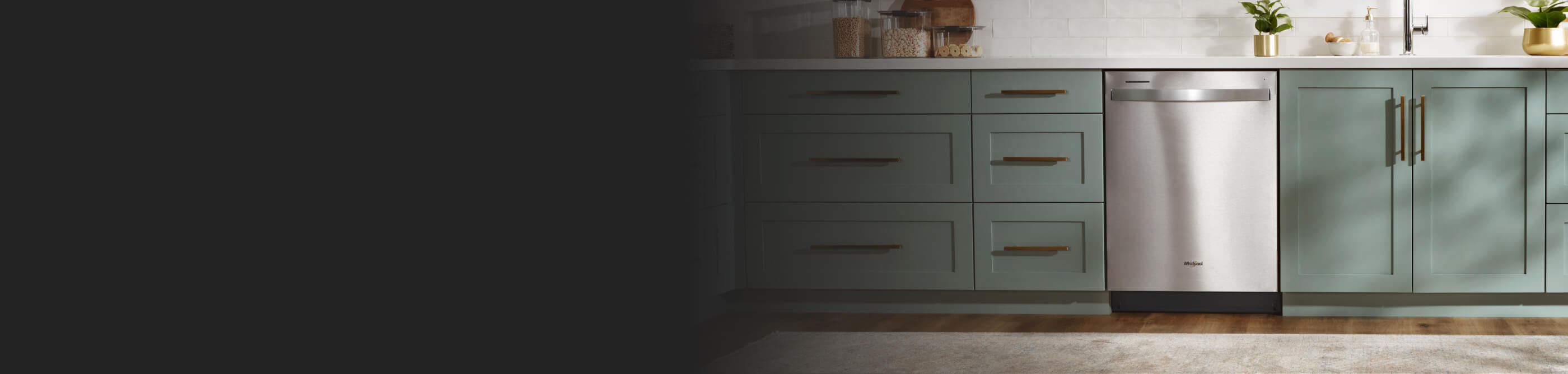 A Whirlpool® Dishwasher surrounded by teal cabinetry