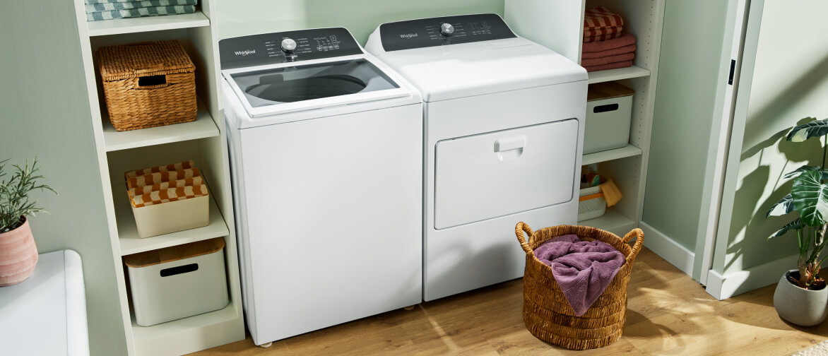 A Whirlpool® Top Load Washer and Front Load Dryer in a laundry room
